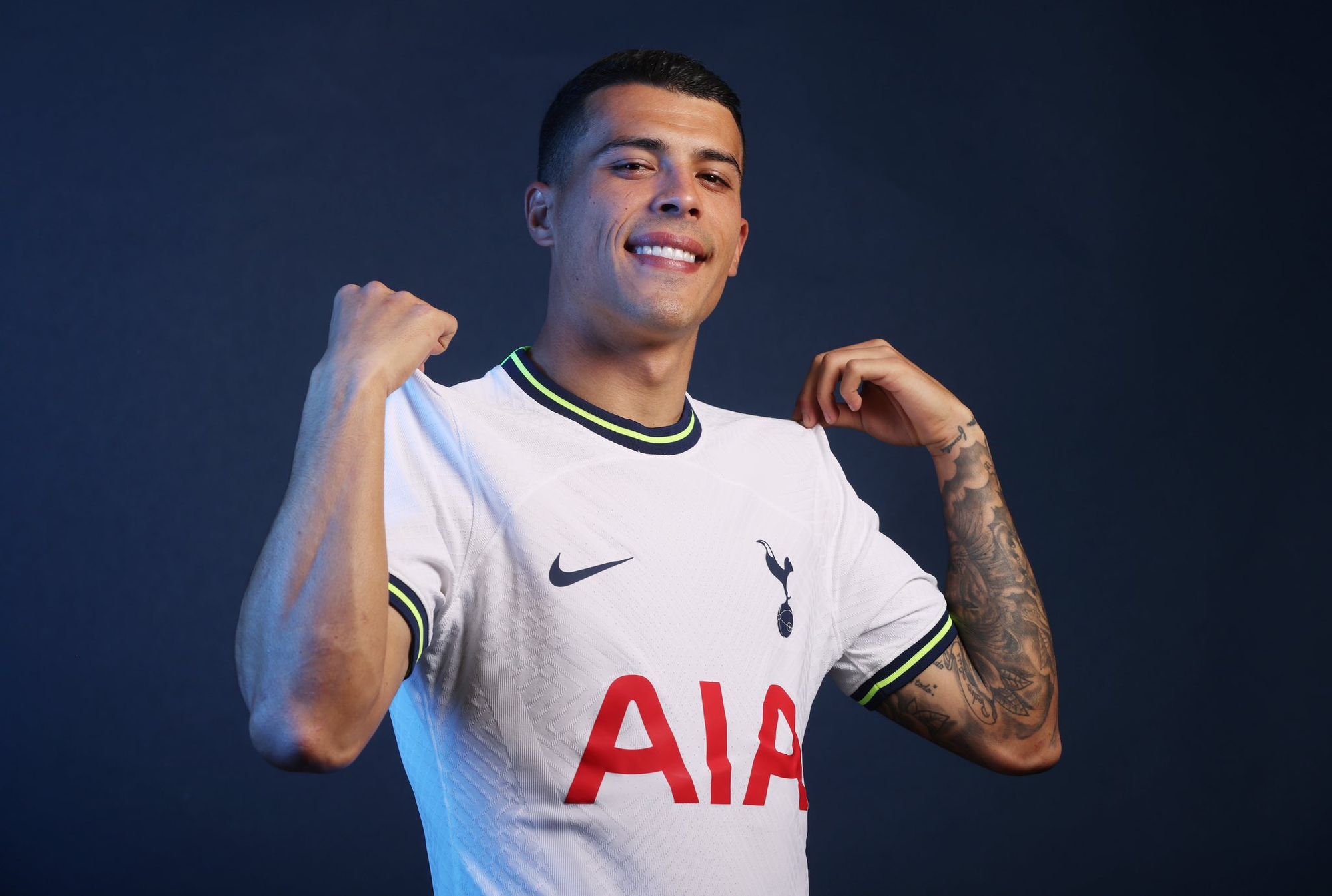 Pedro Porro shows off his new Spurs home shirt.