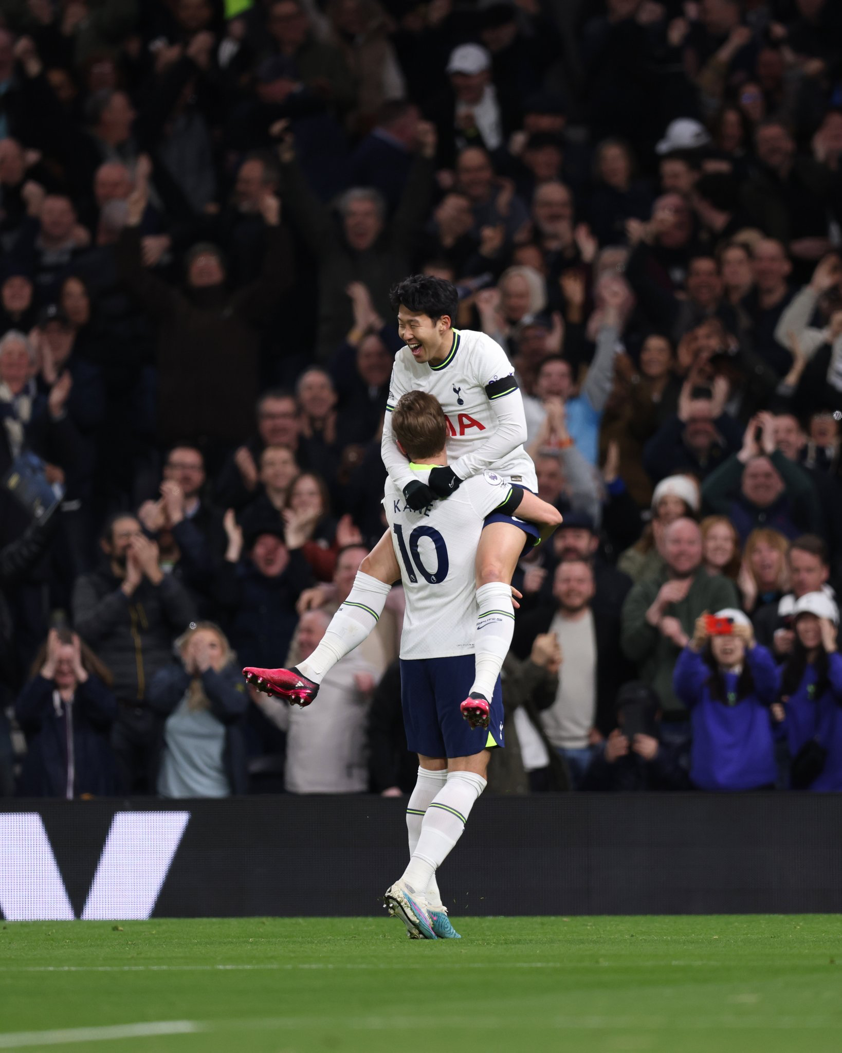 Son Heung-min jumps into Harry Kane's arms to celebrate Son's goal.