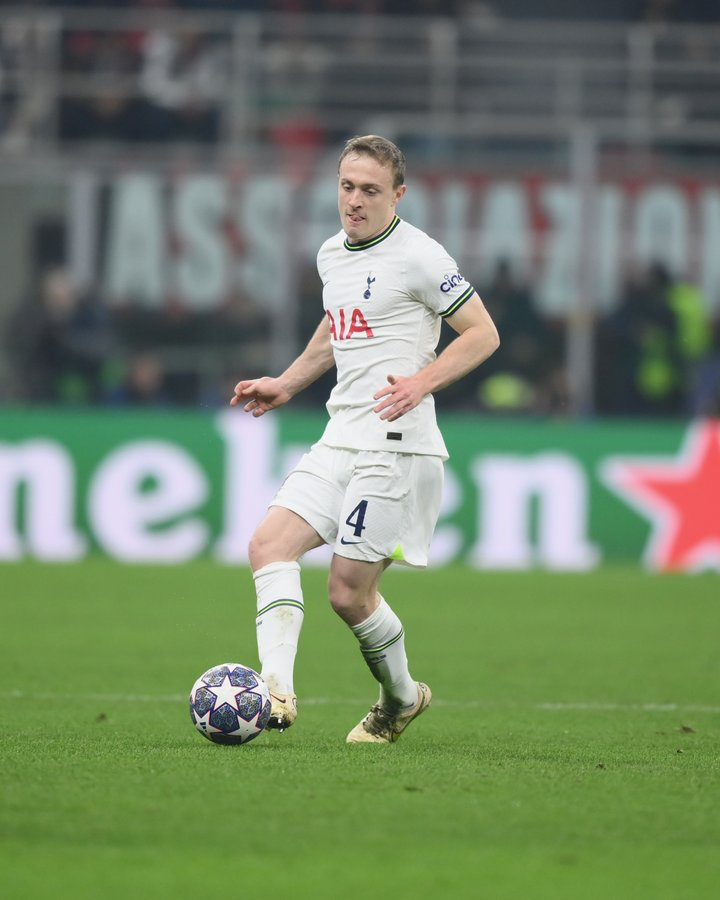 Oliver Skipp sticks his tongue out in concentration while kicking the ball.