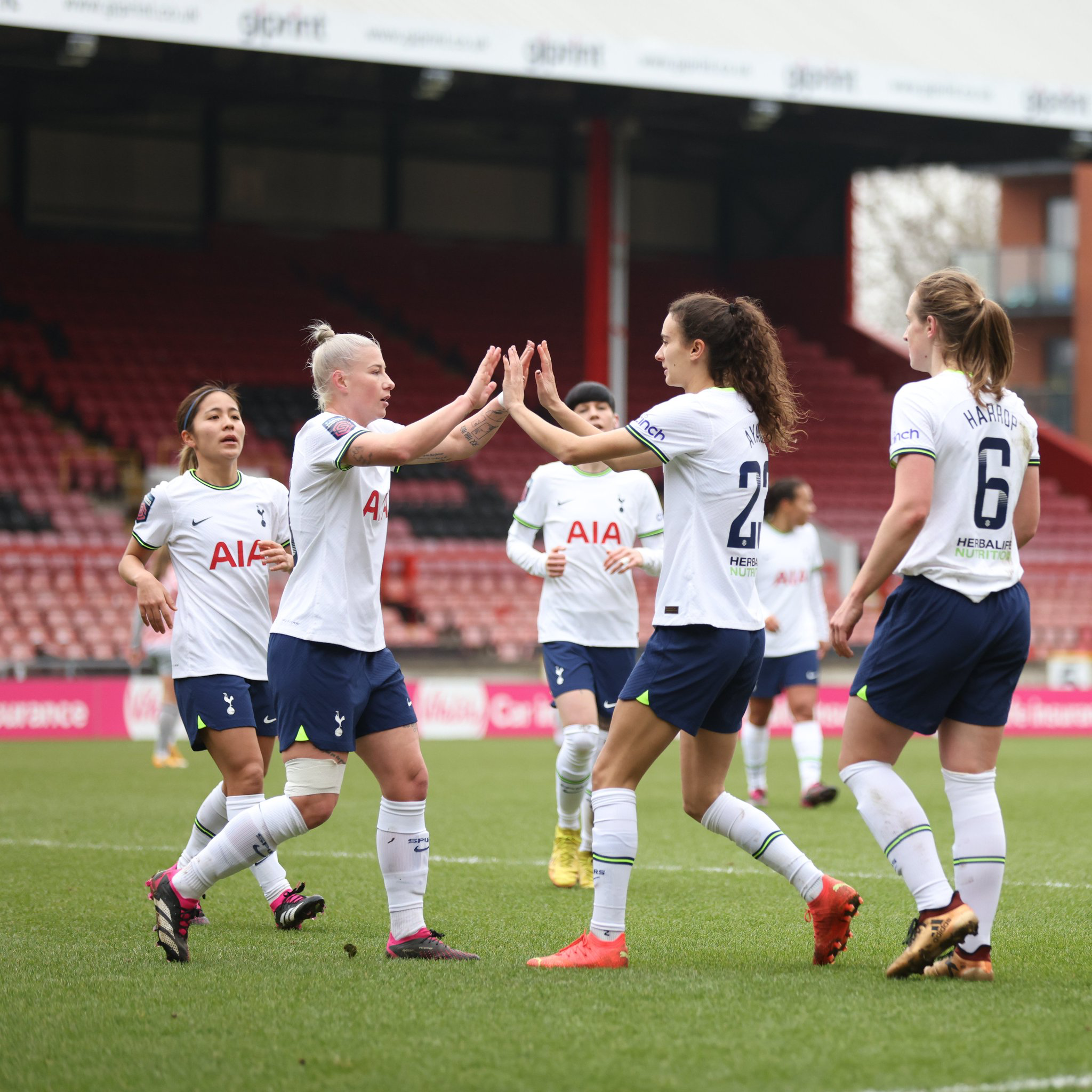 Beth England high-fives Rosella Ayane after receiving an assist from her.