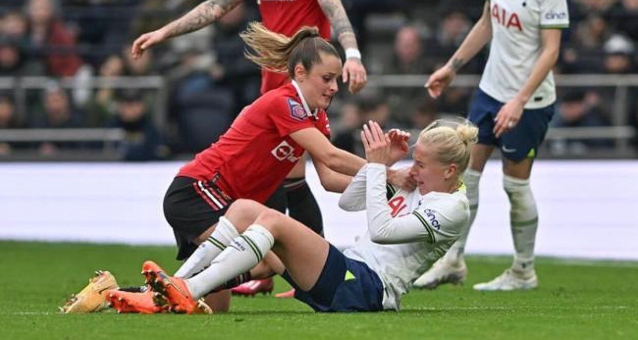 Ella Toone uses both hands to shove Eveliina Summanen roughly back to the ground after a tangle of legs.