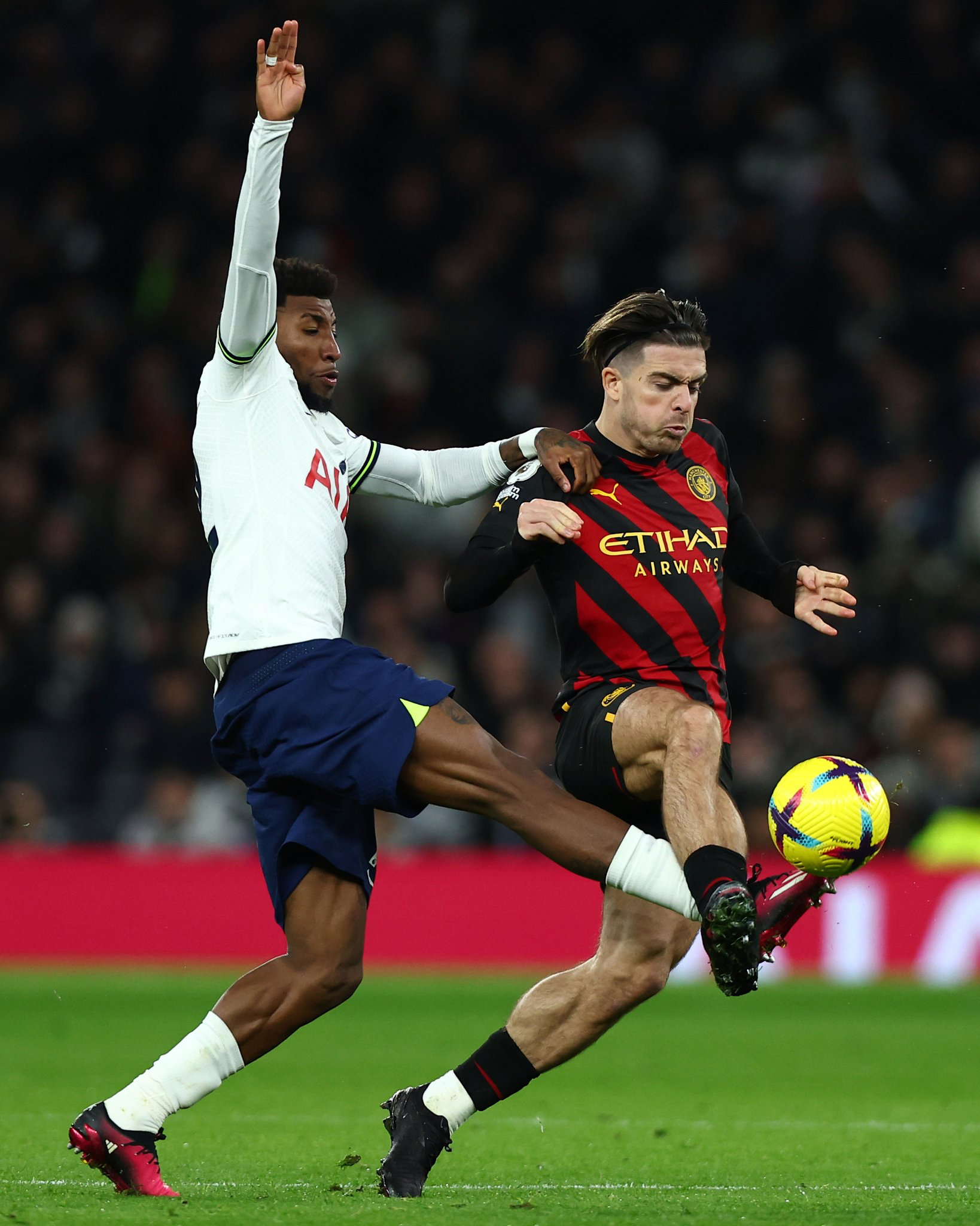 Emerson Royal engages in a fierce challenge with Jack Grealish.