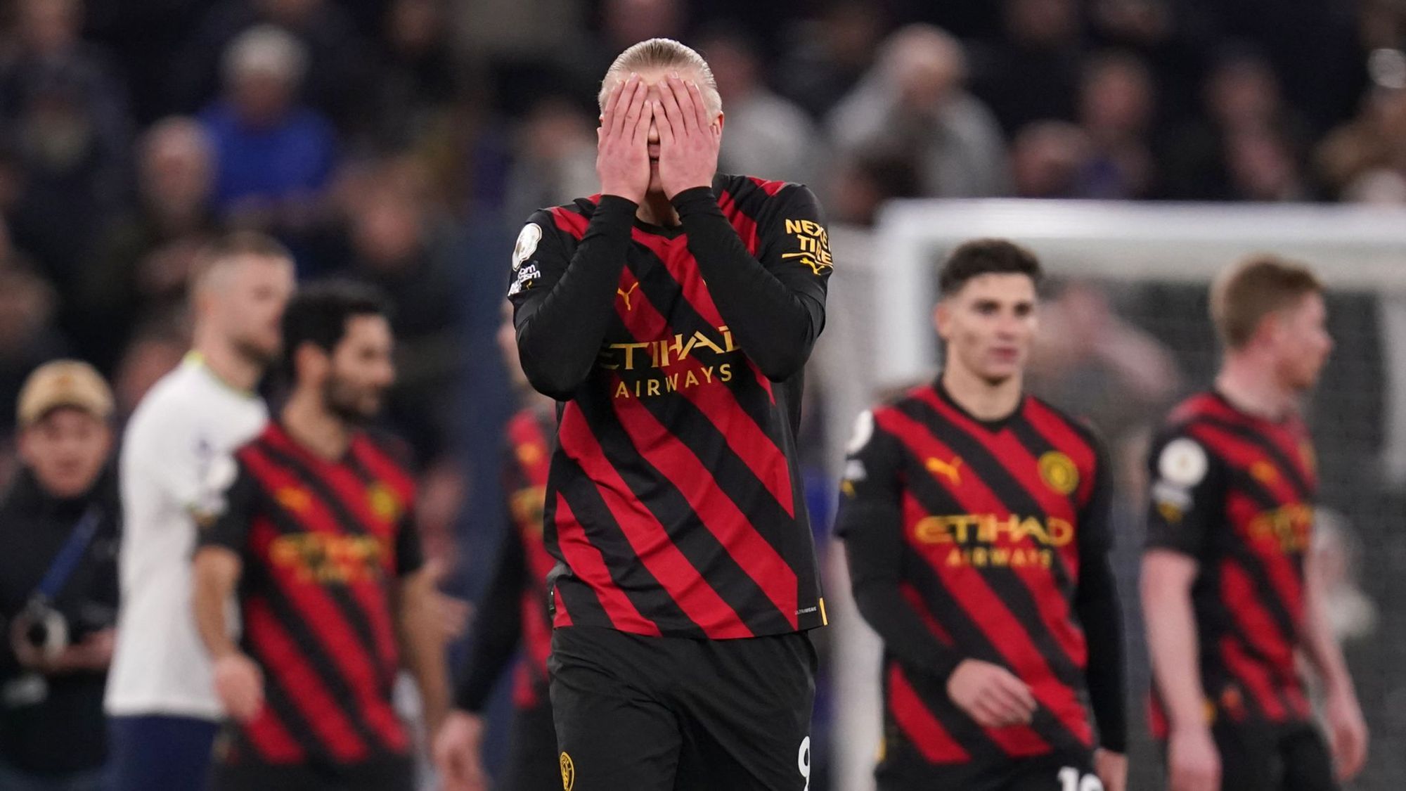 Erling Haaland holds his hands to his head in frustration.