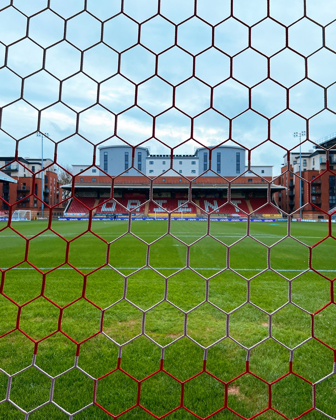 A view of one of the stands at Brisbane Road as seen through the net of one of the goals.