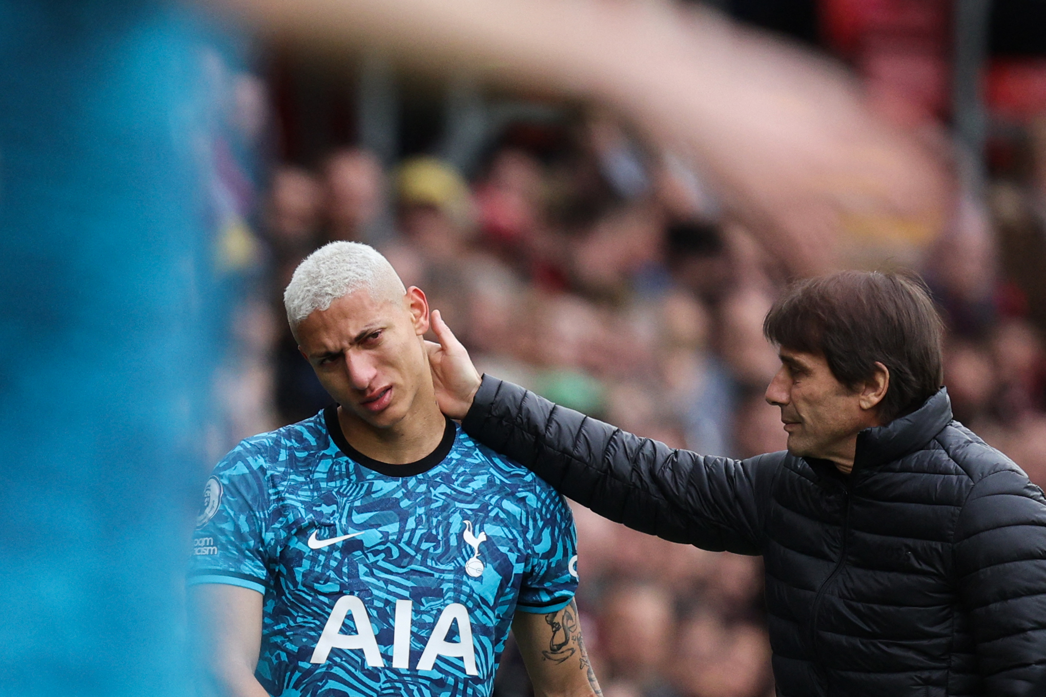 Richarlison brushes off a touch from Antonio Conte after exiting the Southampton game with an injury.