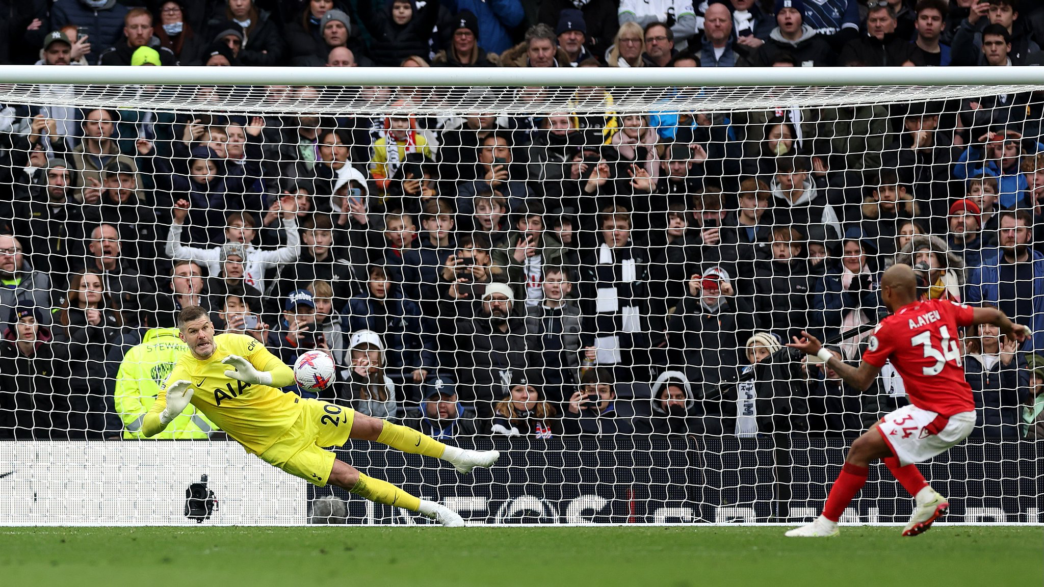 Fraser Forster saves André Ayew's penalty kick.