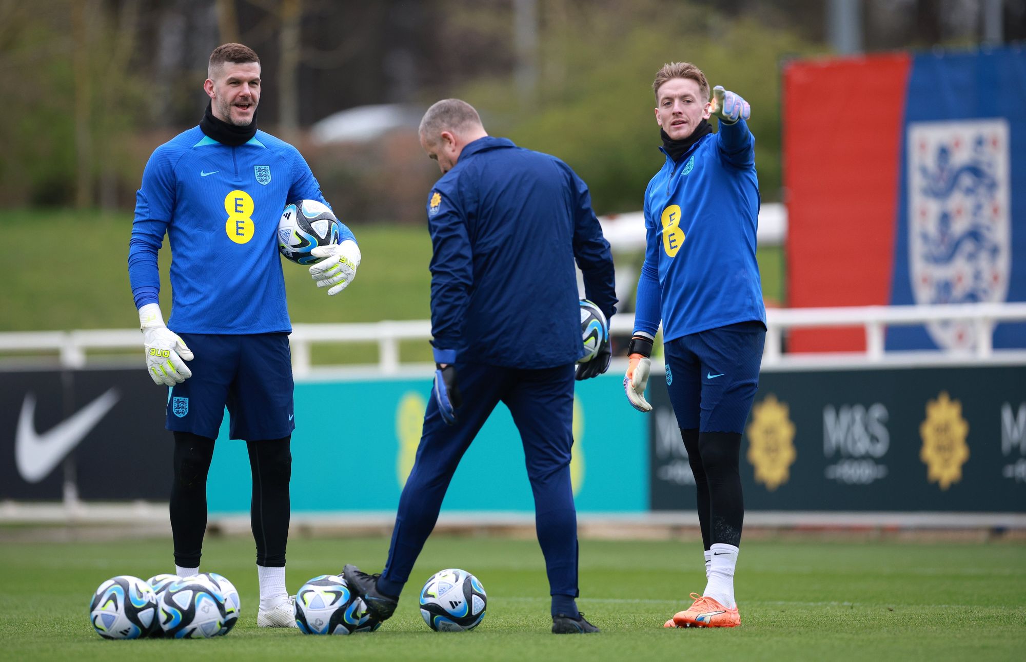 Fraser Forster in training with the England squad, alongside a coach and Jordan Pickford. 