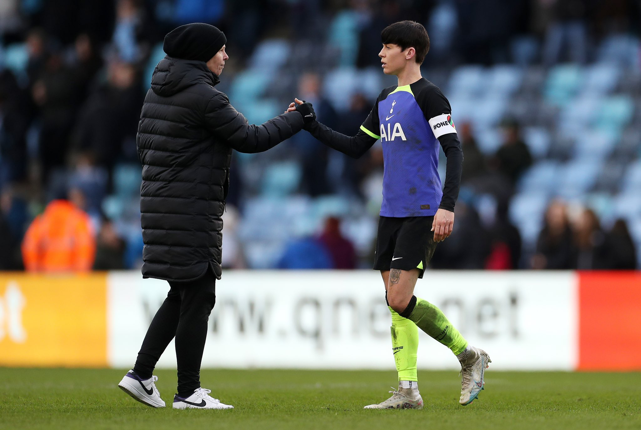 Rehanne Skinner clasps hands with Ashleigh Neville after the Manchester City loss.