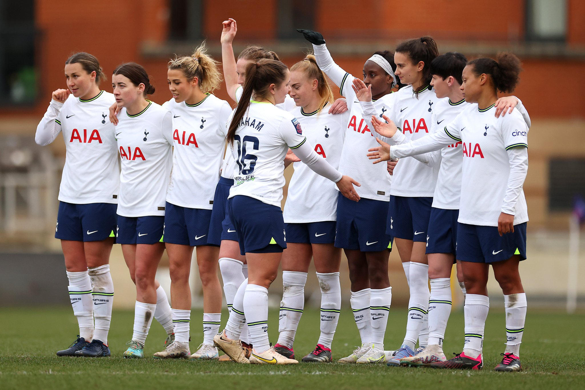 Kit Graham rejoins Spurs' penalty shootout line after successfully making her penalty.