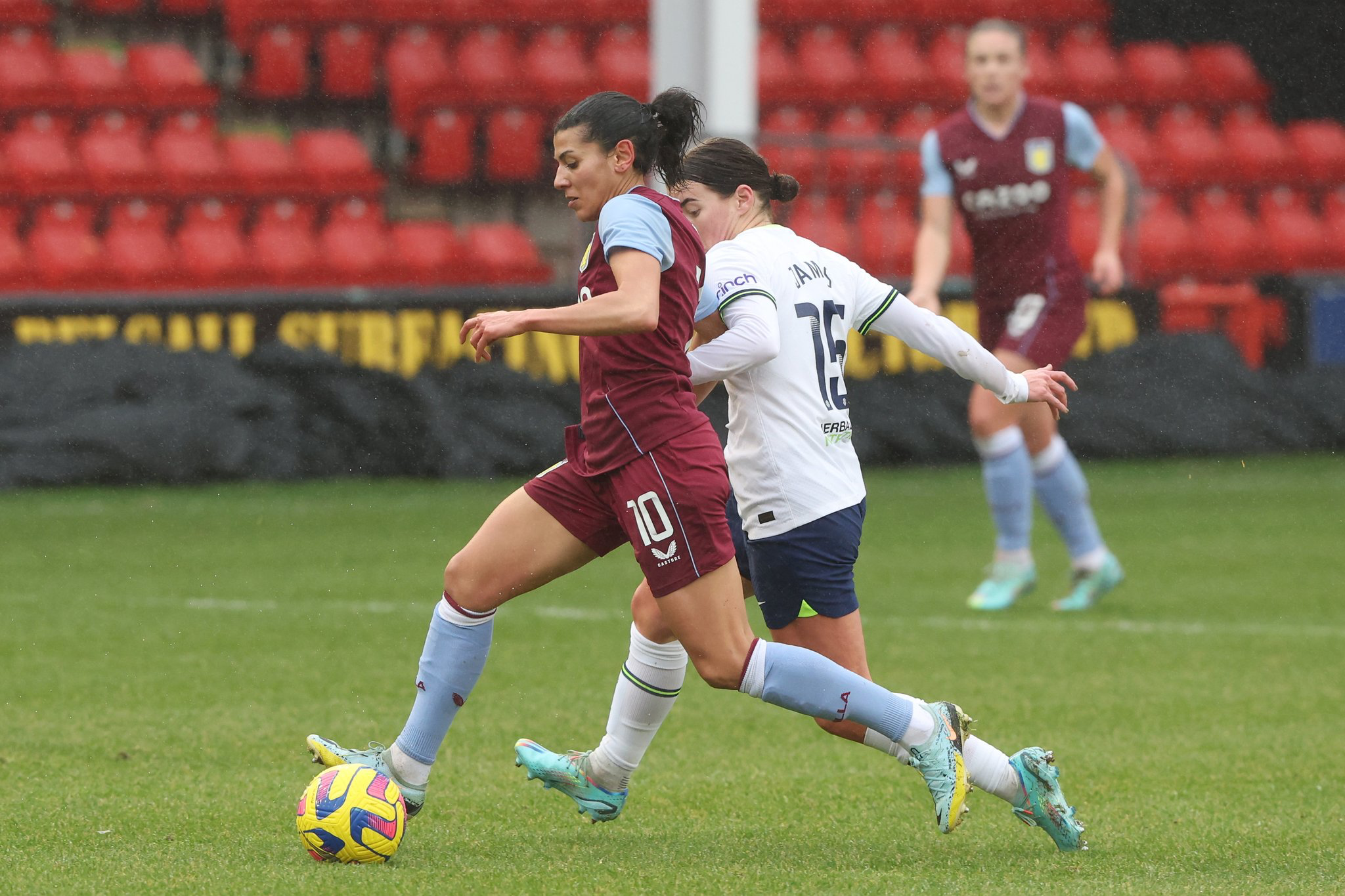 Angharad James challenging Aston Villa's Kenza Dali for possession.