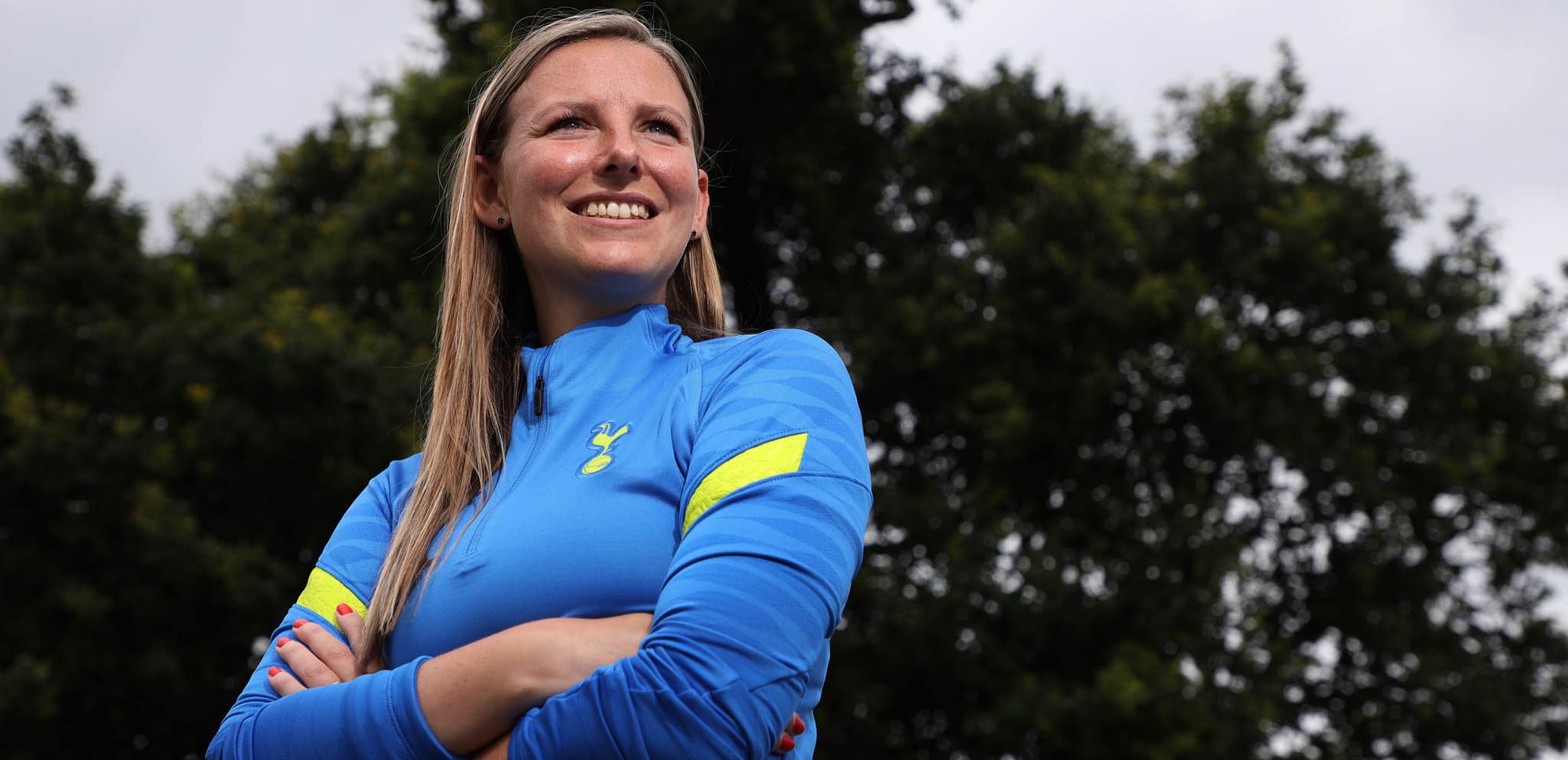 Vicky Jepson smiles in a Tottenham training shirt.