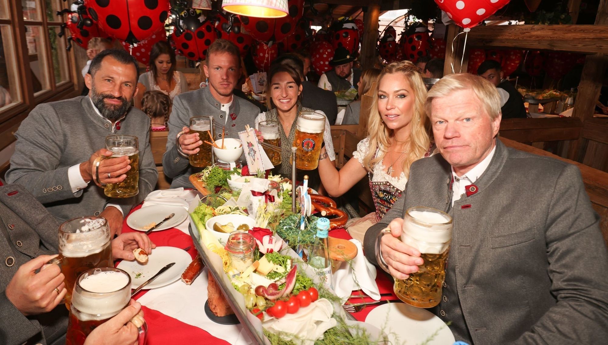 Brazzo, Nagelsmann, and Kahn look uncomfortable sitting with each other at Oktoberfest. 