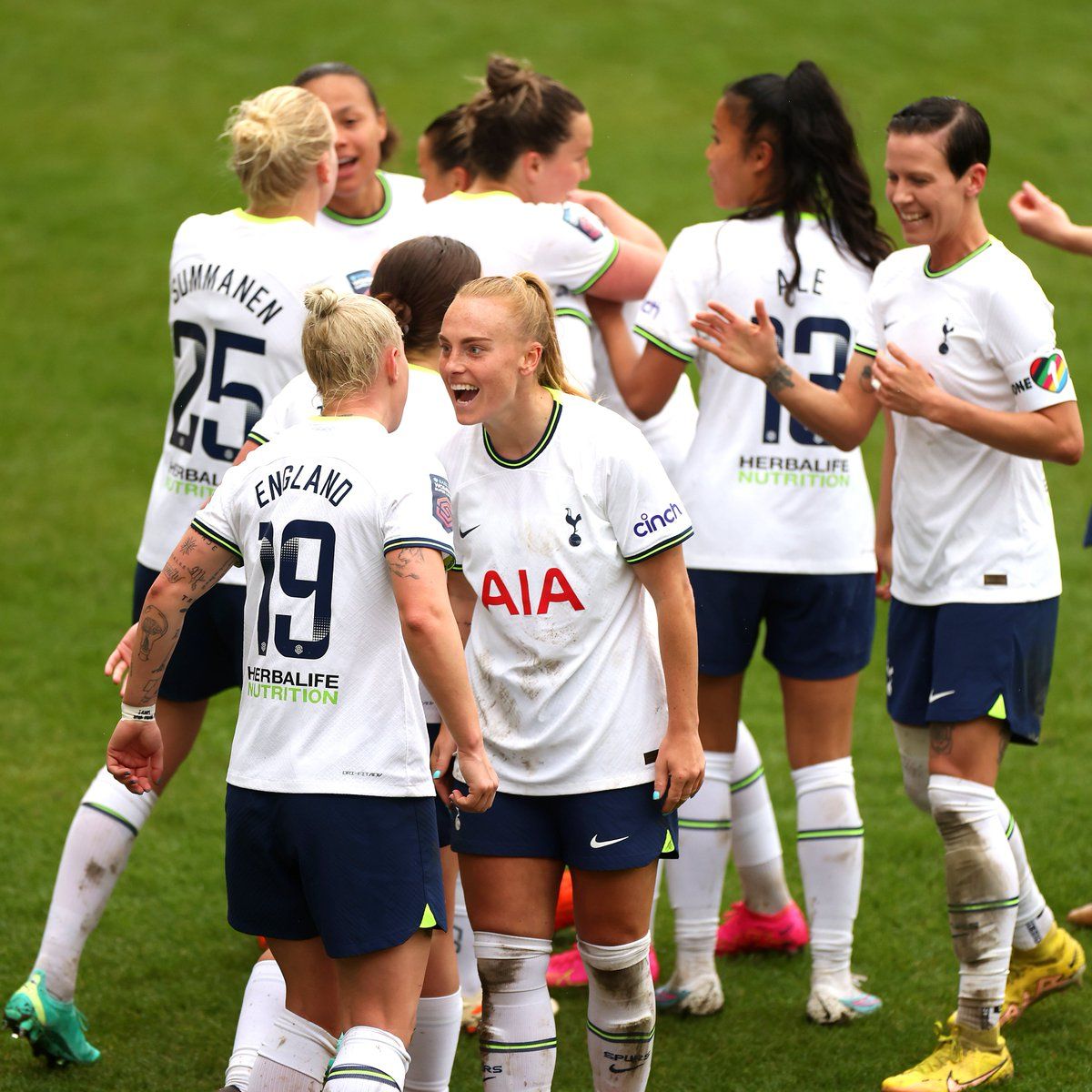 Molly Bartrip celebrates with Beth England in the foreground, while other players cluster in the background.