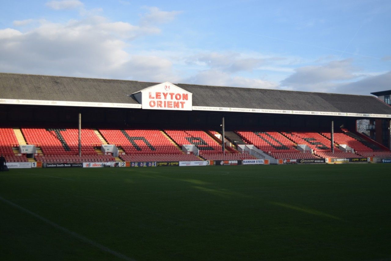 A shot of one stand at Brisbane Road showing the Leyton Orient side on the roof and "The O's" on the seats.
