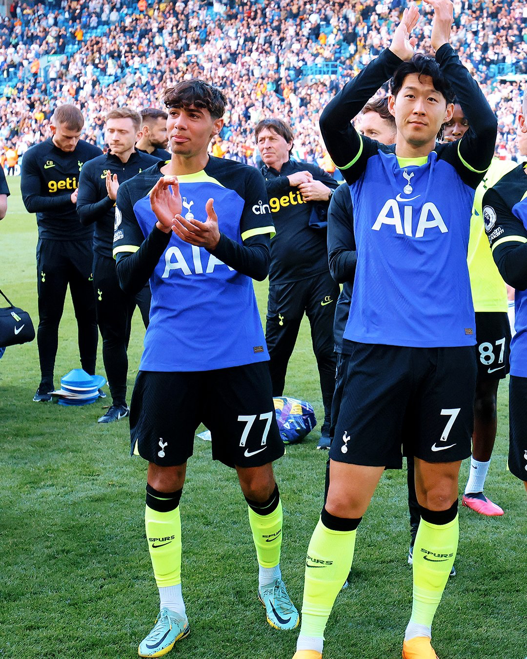 George Abbott claps for the away fans next to Son Heung-min after making his Premier League debut.