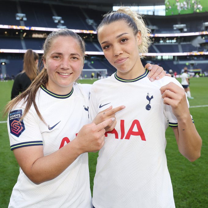 Kit Graham and Celin Bizet point to the Tottenham crest while celebrating after the game.