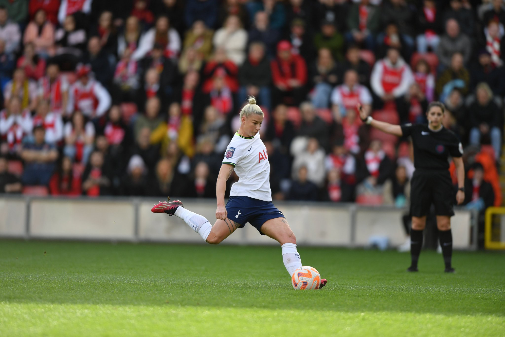 Beth England winds up to take a penalty kick.