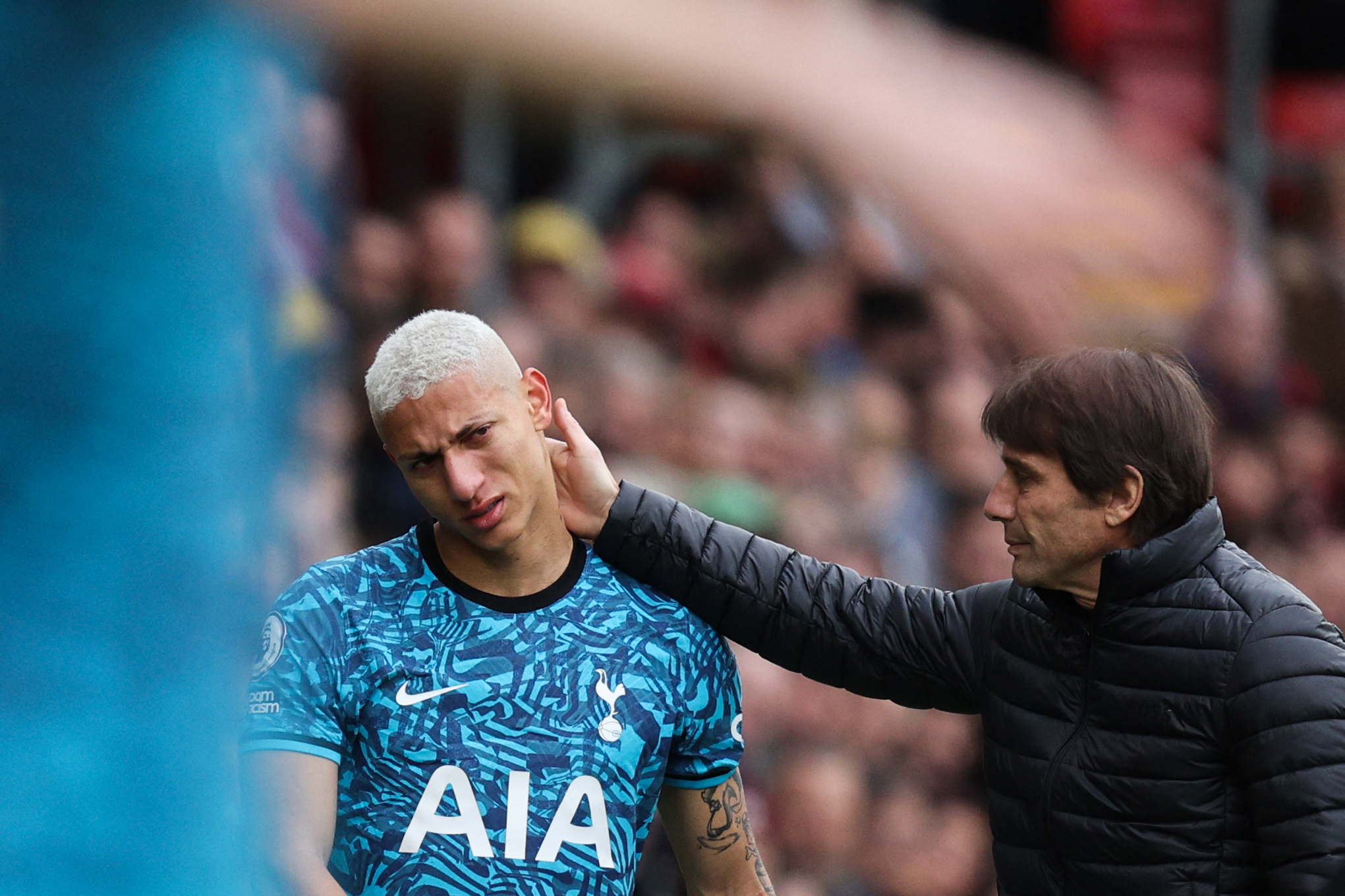 Antonio Conte attempts to comfort Richarlison has he comes off the pitch early due to an injury.