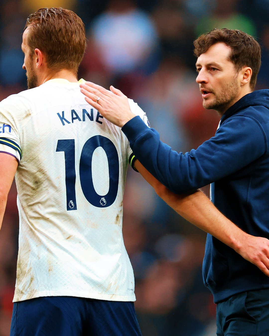 Ryan Mason claps Harry Kane on the back during a game.