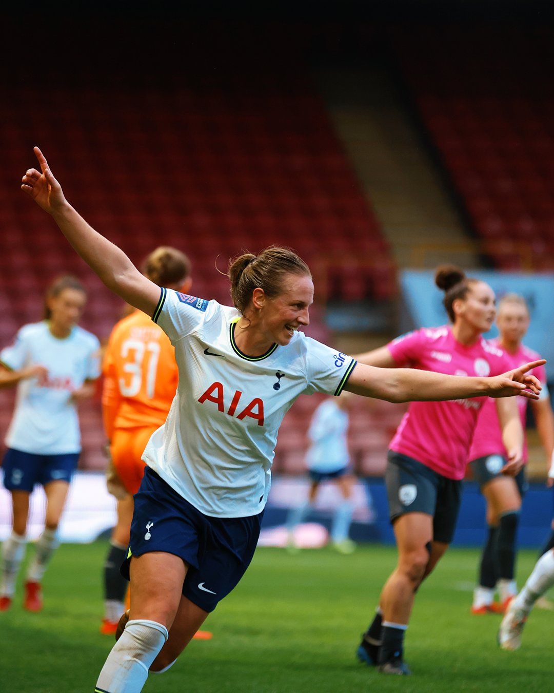 Kerys Harrop extends her arms in celebration.