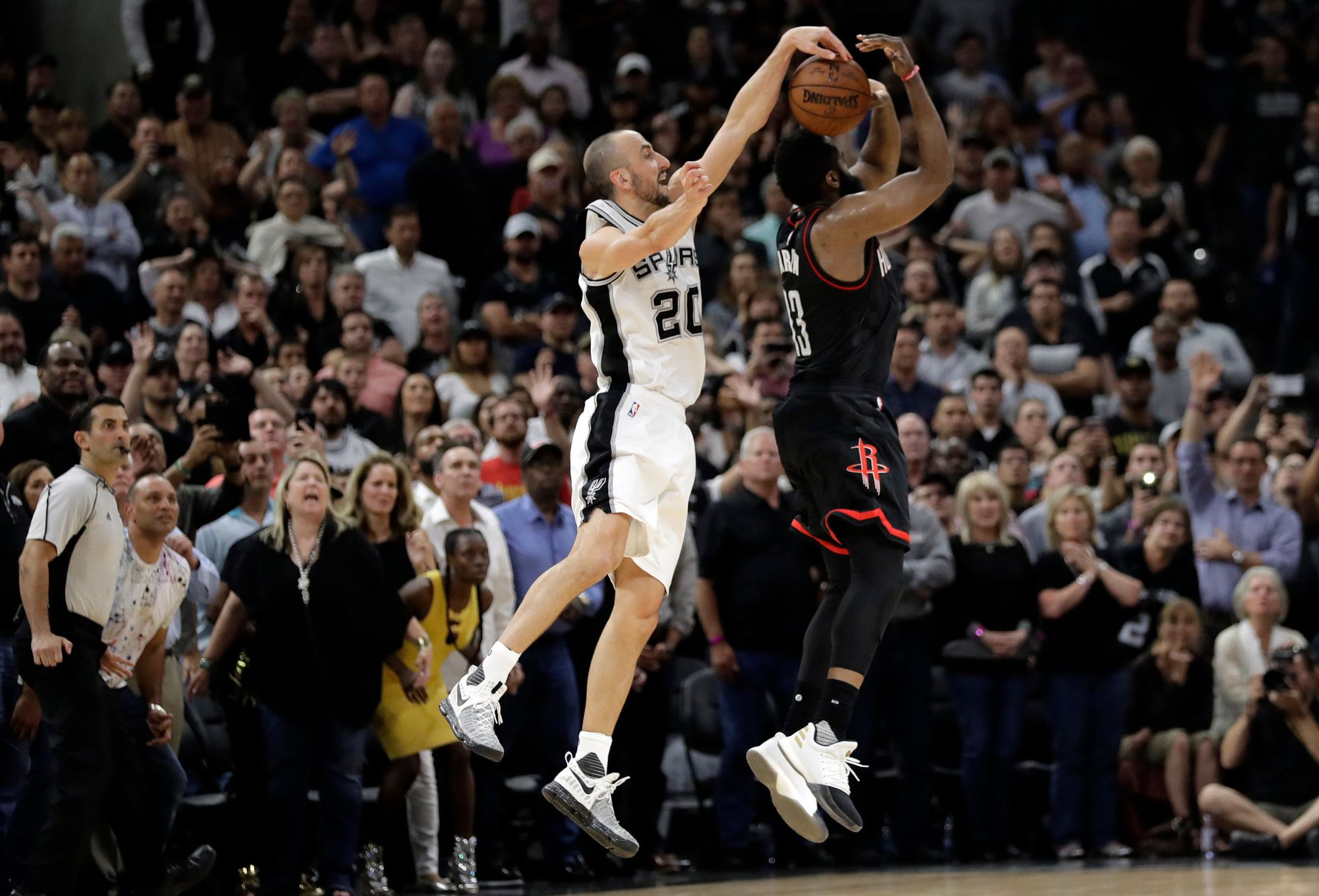 Manu Ginobili blocks James Harden's shot.