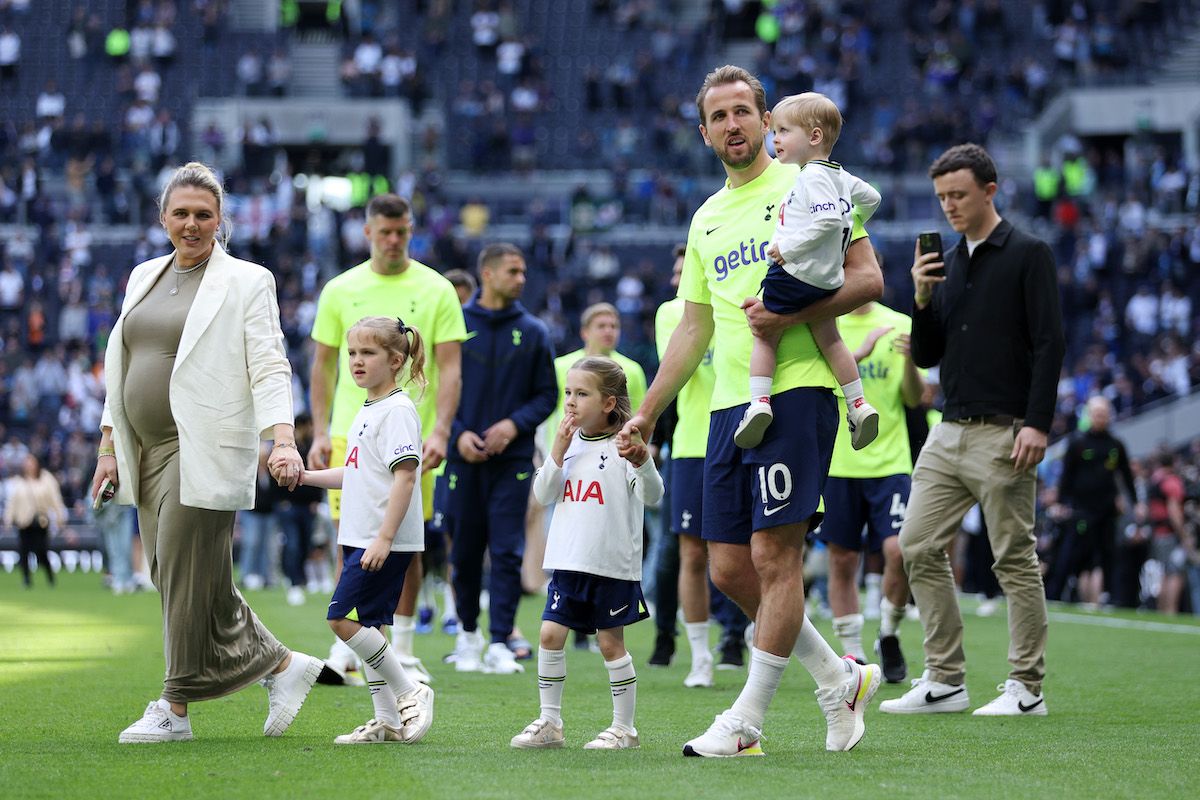 Harry Kane walks on the pitch with his family.