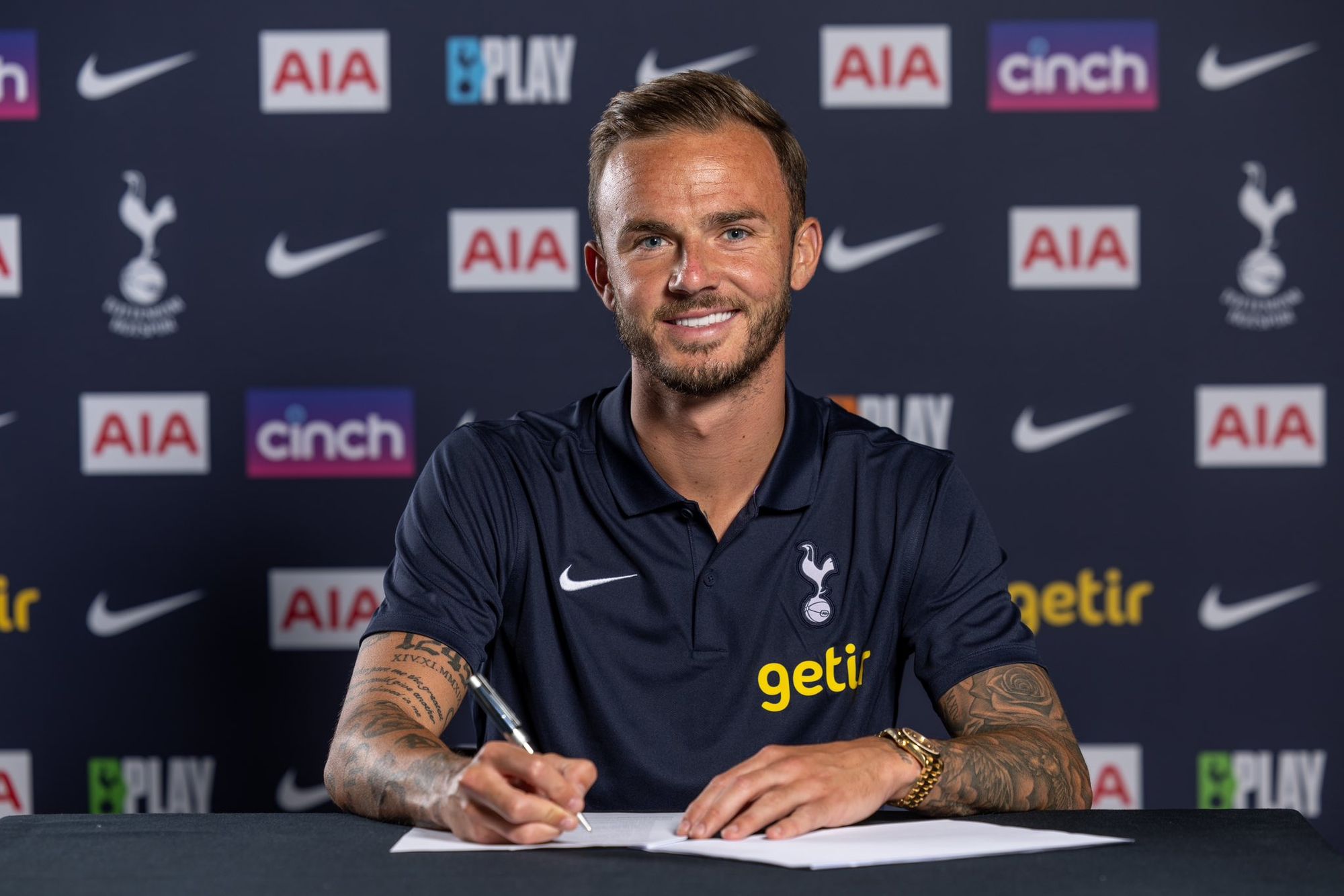 James Maddison signs his Spurs contract.