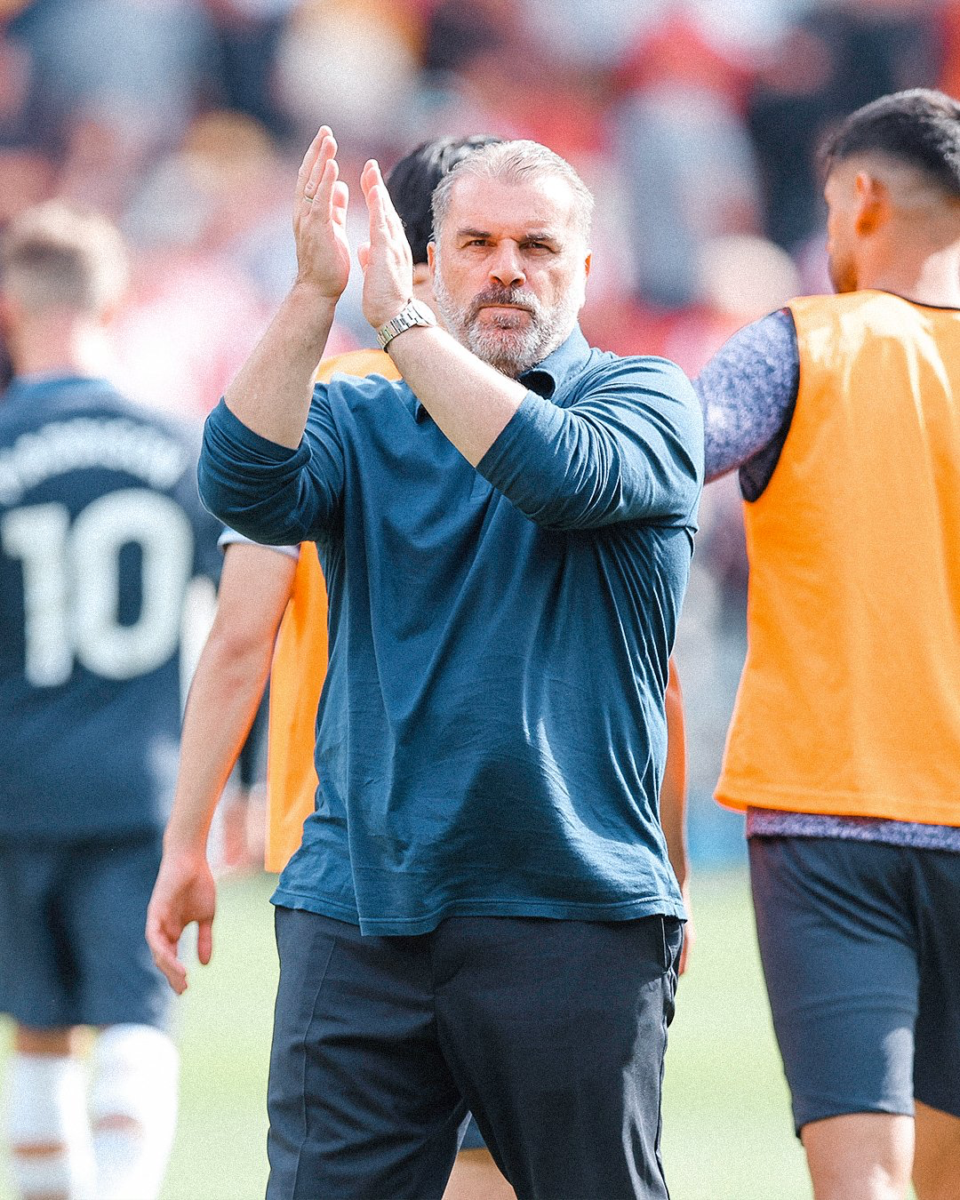 Ange Postecoglou claps for the fans after the game.