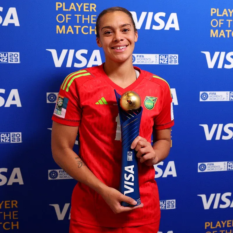 Becky Spencer holding up her Player of the Match trophy after the Brazil game.