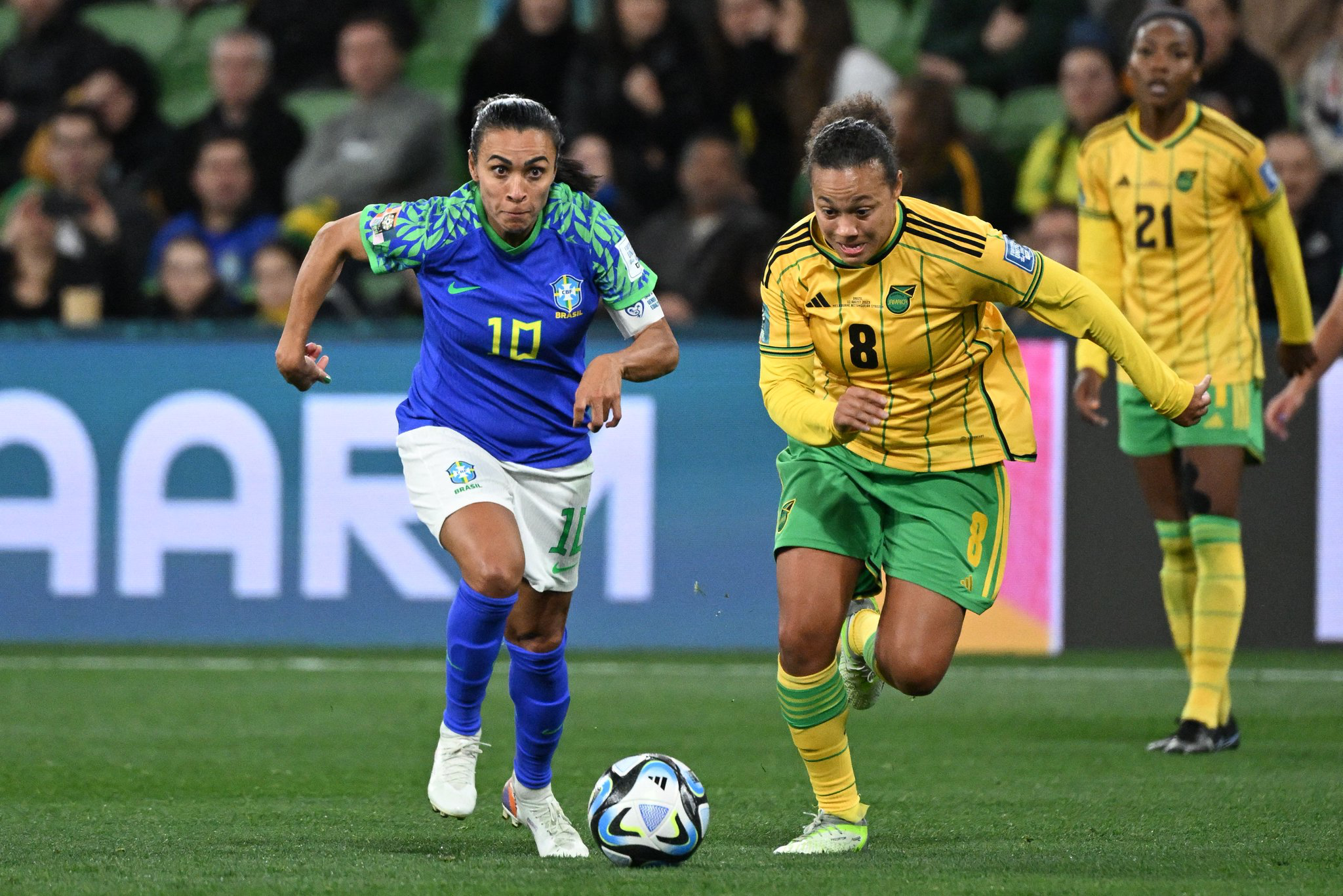 Drew Spence races for the ball alongside Marta during Jamaica vs Brazil.