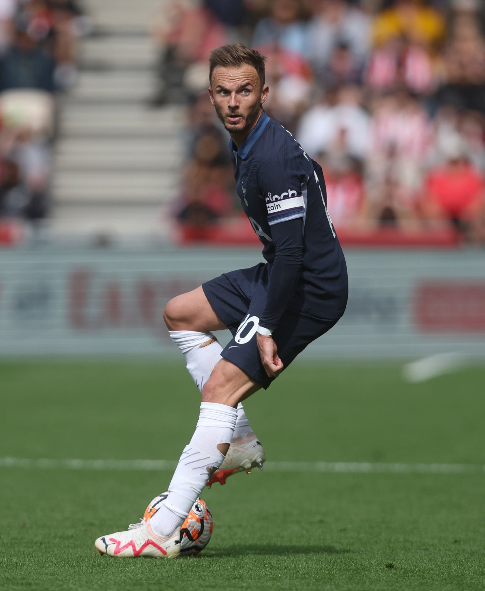 James Maddison assesses the pitch as he controls the ball.