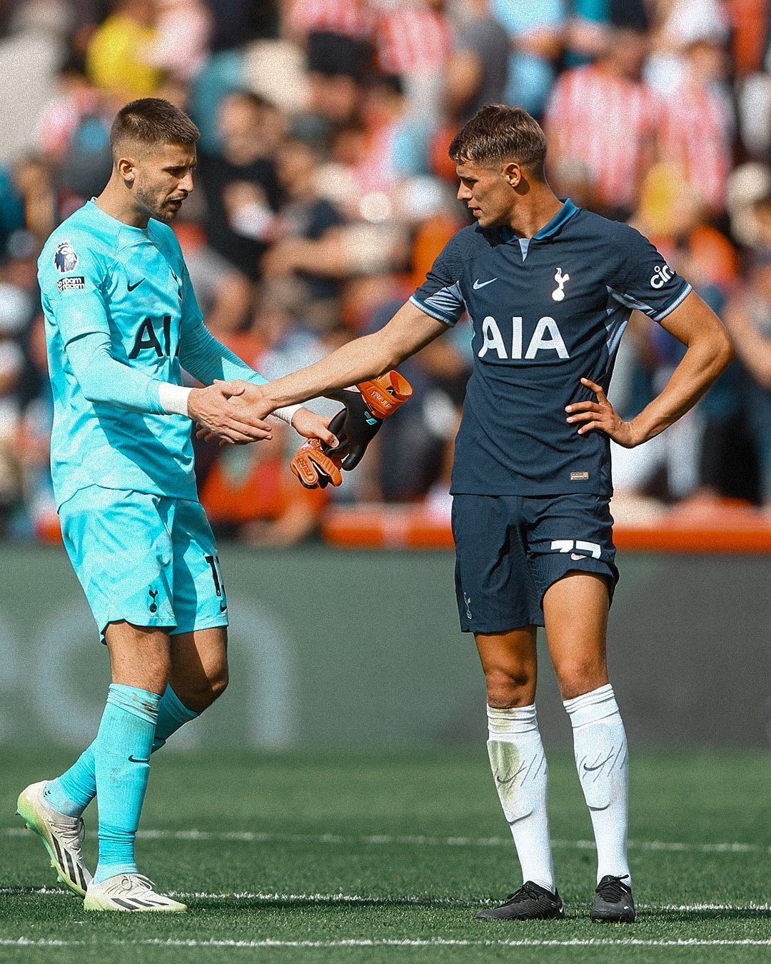 Vicario and Van de Ven high five after the game.