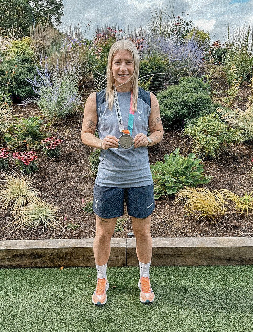 Beth England shows off her World Cup silver medal at the Tottenham training ground.