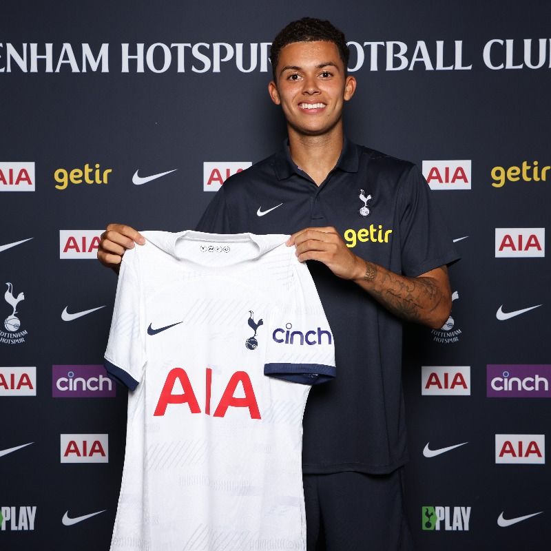 Brennan Johnson holds up his new Spurs kit.