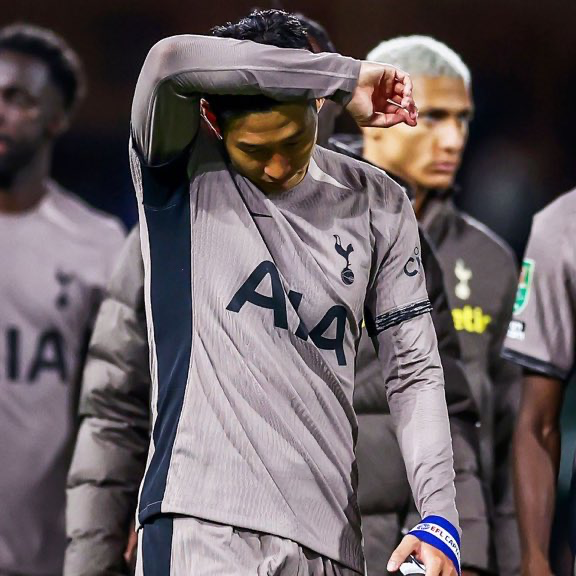 Son Heung-min holds his arm up to his elbow in frustration.