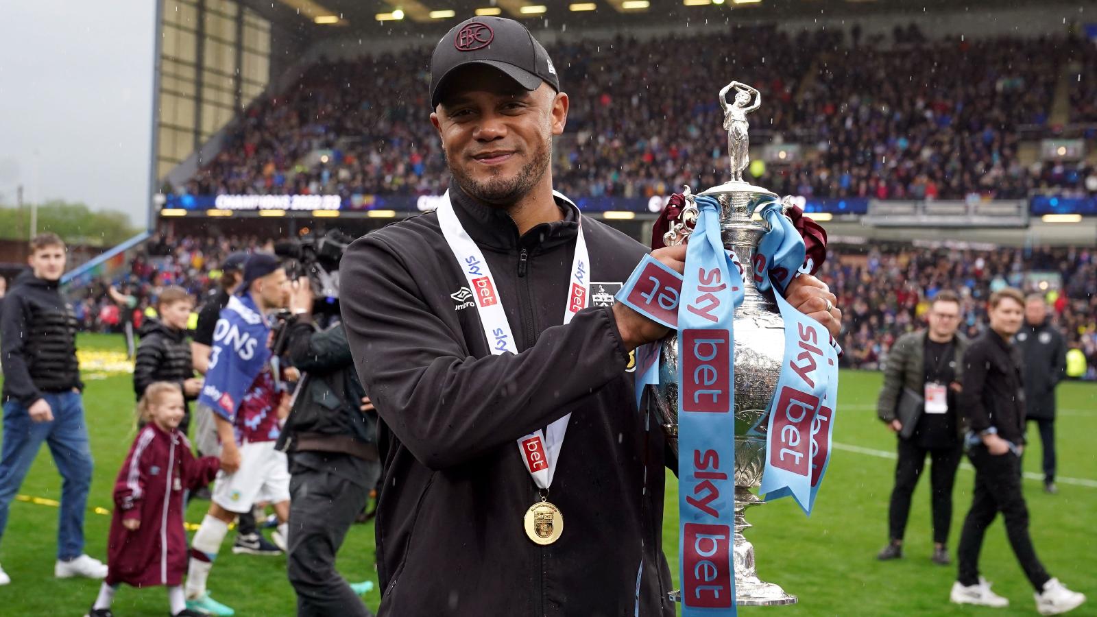 Vincent Kompany holds the Championship trophy.