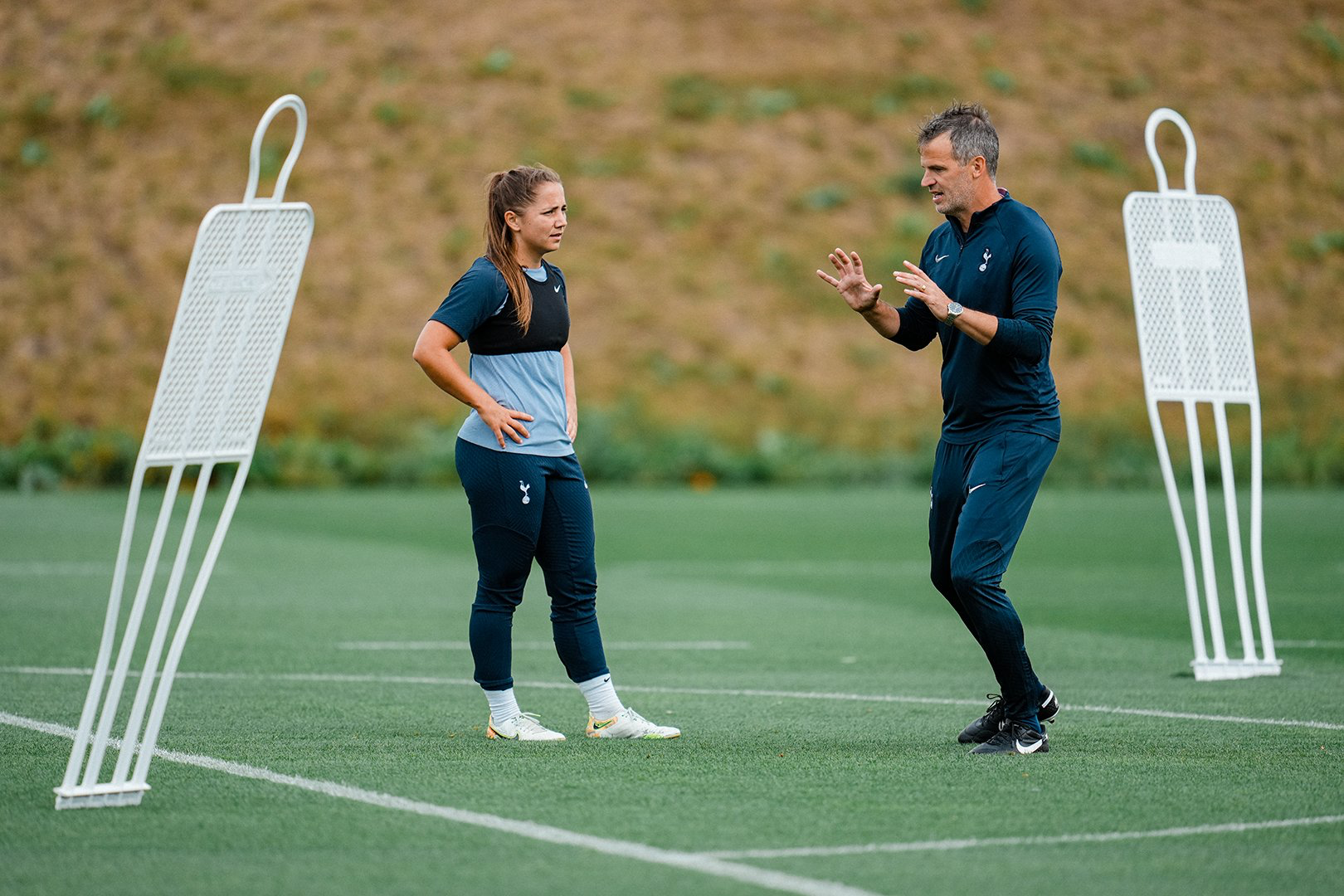 Robert Vilahamn gives instructions to Kit Graham on the training pitch.