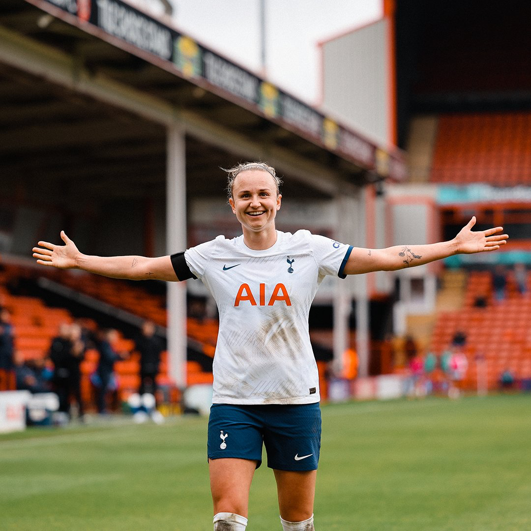 Martha Thomas spreads her arms in victory to celebrate her hat trick.