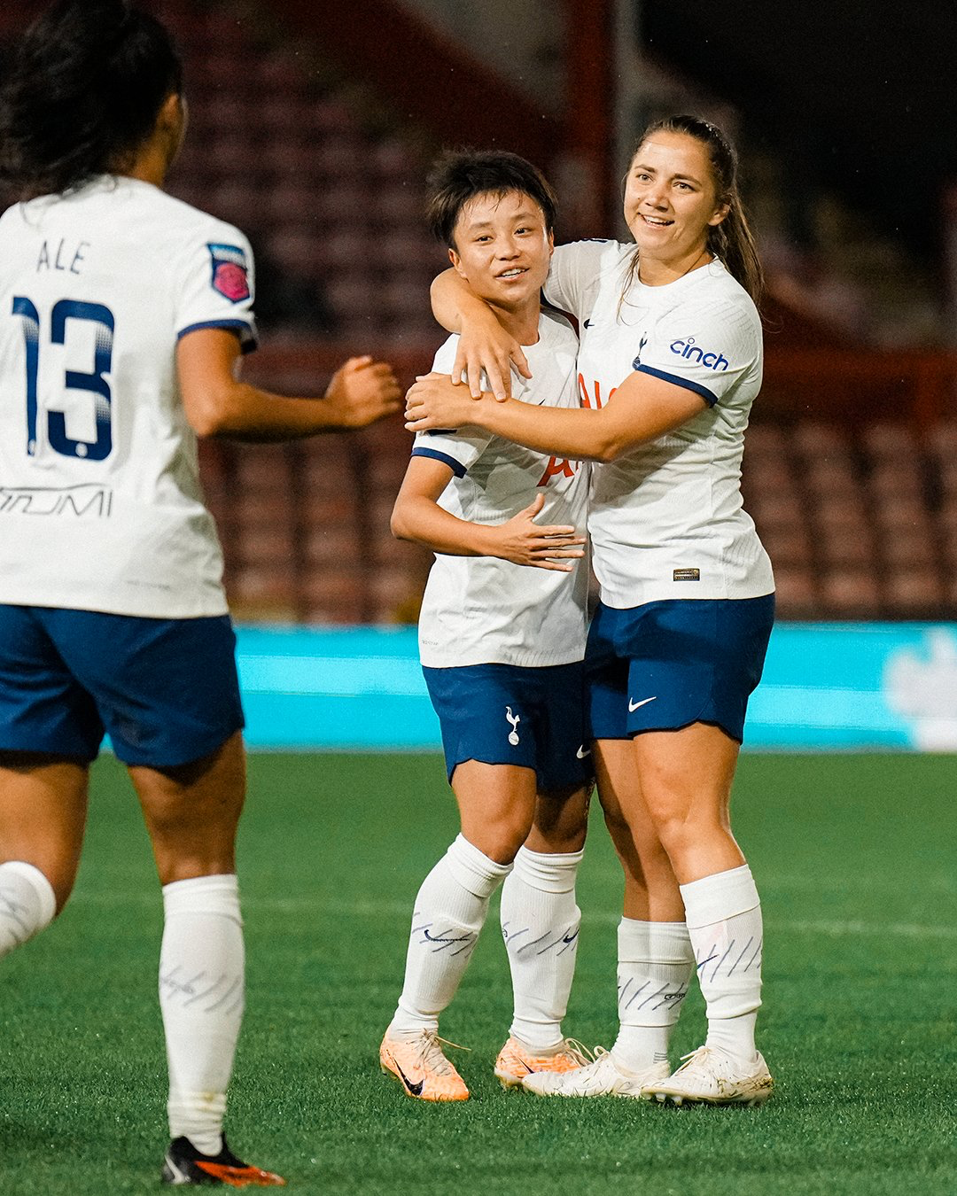 Zhang Linyan celebrates her debut goal with Kit Graham.