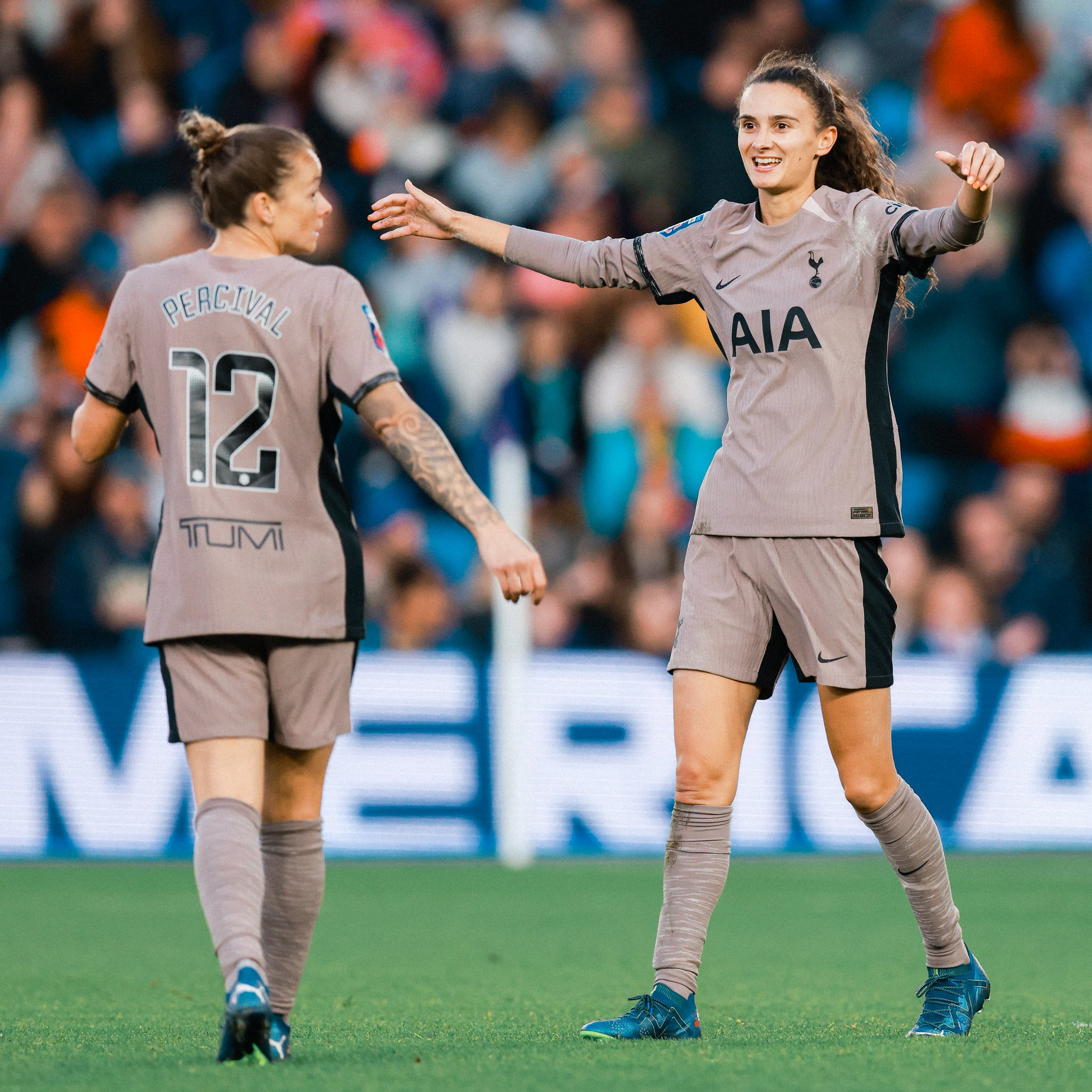 Rosella Ayane goes to hug Ria Percival after the latter's goal.