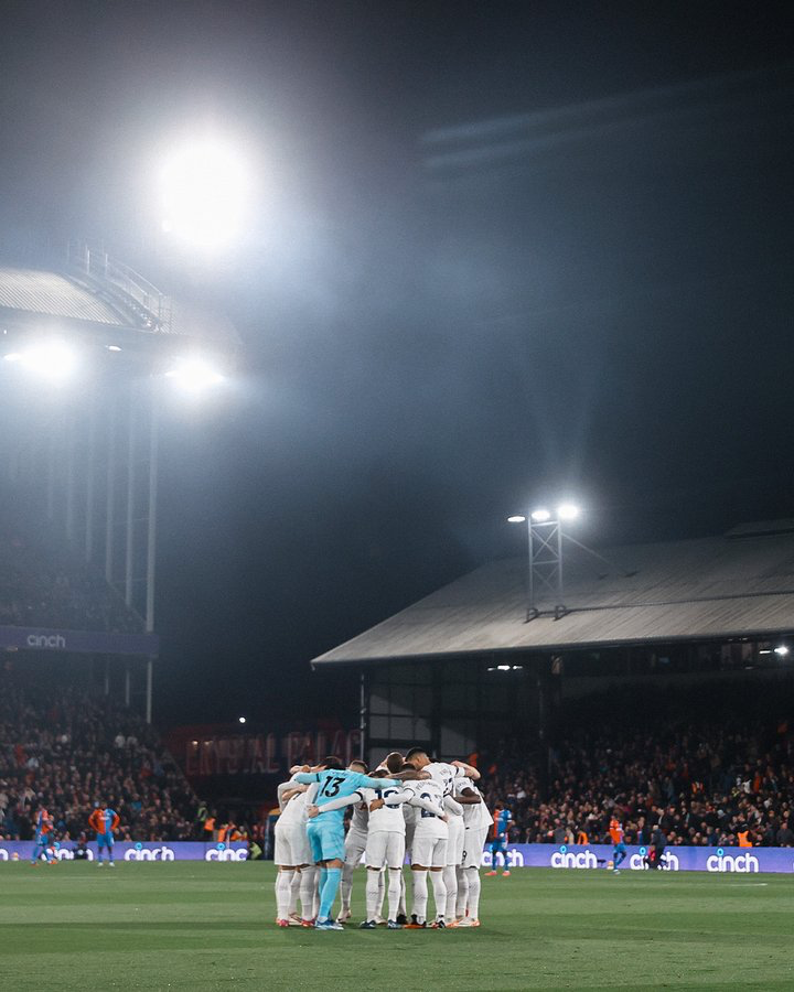 The starting lineup huddles before the game.