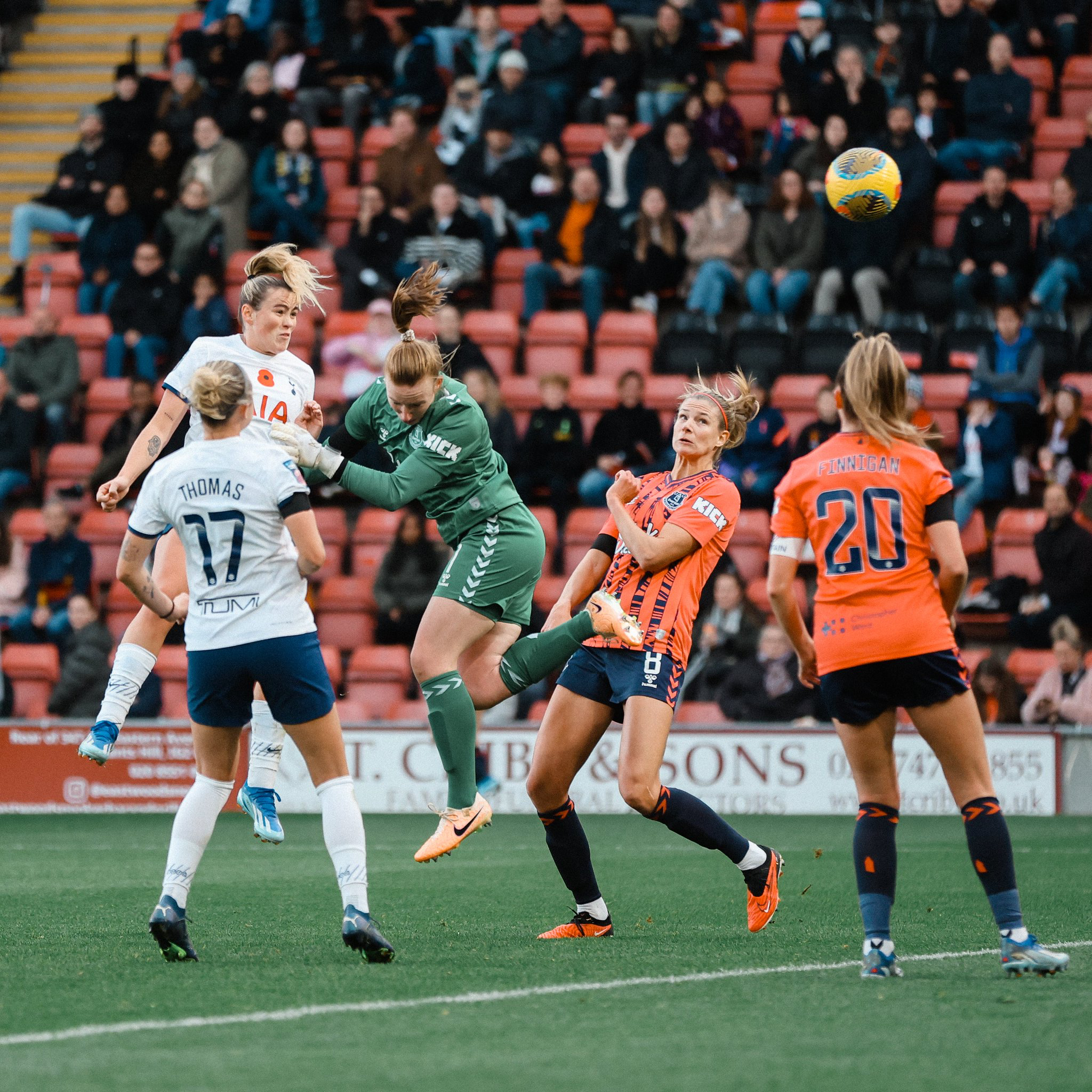 Grace Clinton heads the ball past Everton's keeper.