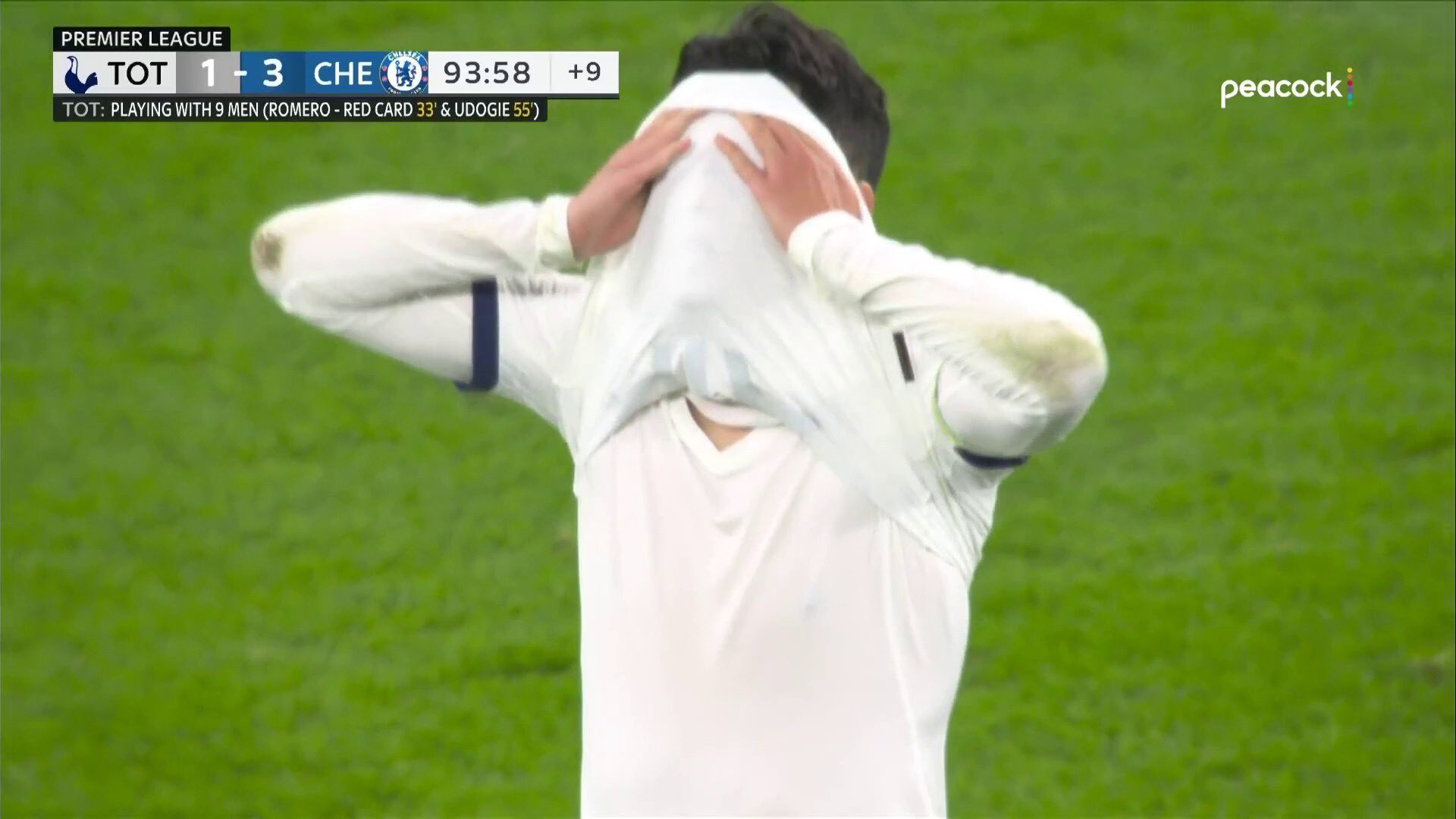 Son Heung-min covers his face with his shirt in frustration.