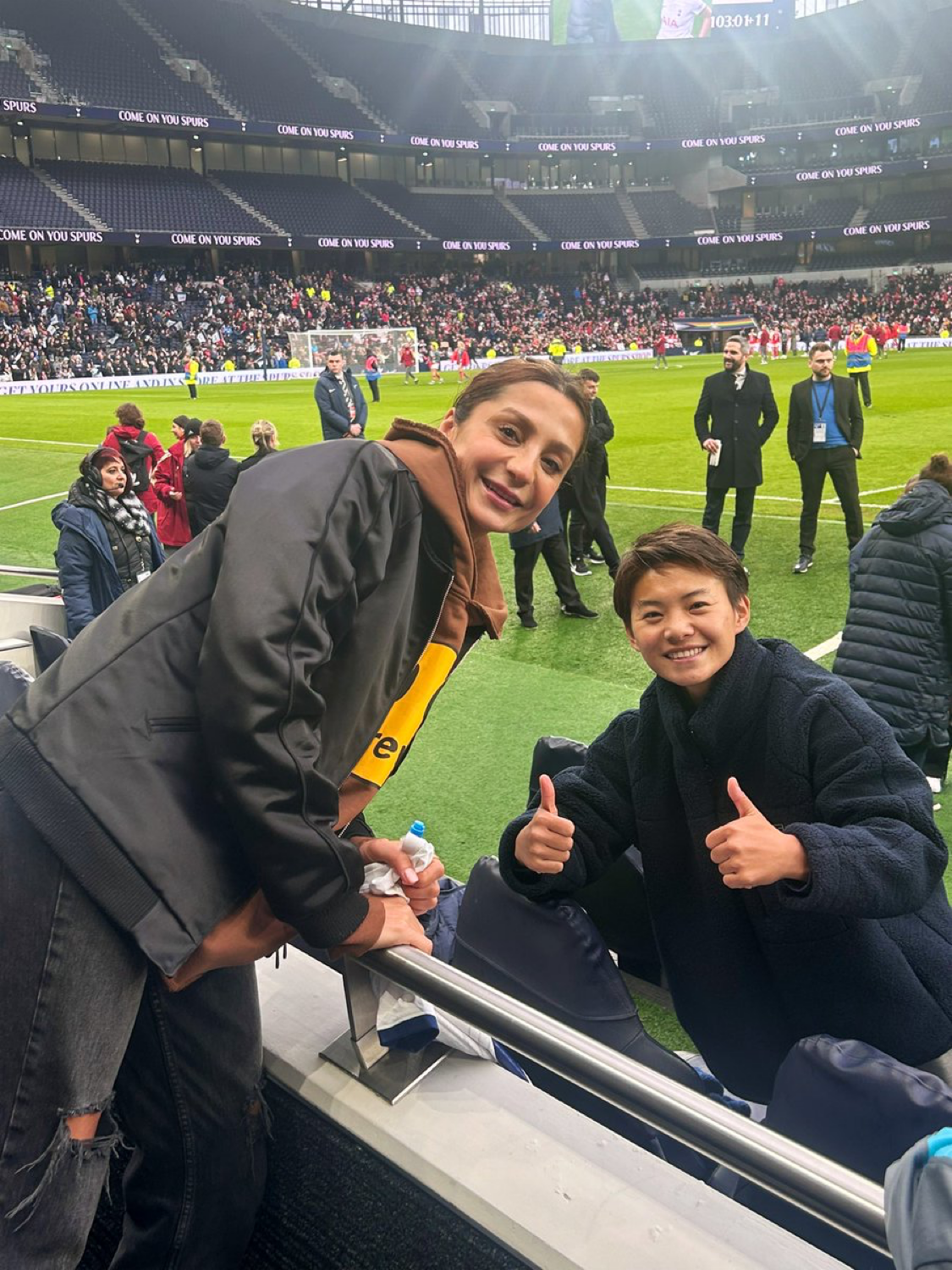 Nadia Nadim poses with Wang Shuang, who gives a thumbs up.