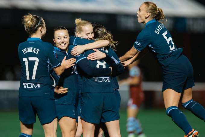 Grace Clinton is swarmed by her teammates to celebrate her early goal.