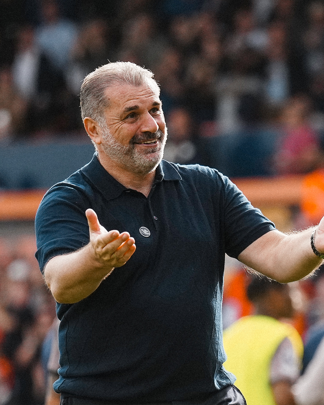 Ange Postecoglou raises his hands in offering.