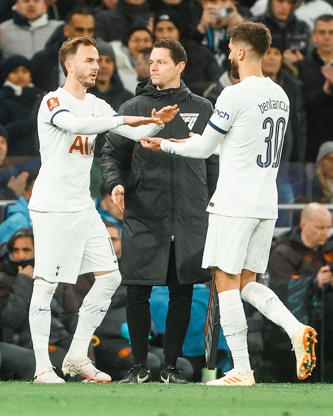 James Maddison high fives Rodrigo Bentancur as he subs in for him.