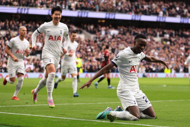 Pape Sarr does a knee slide after scoring.