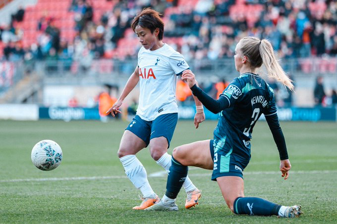 Zhang Linyan challenges for the ball with a Sheffield United player.