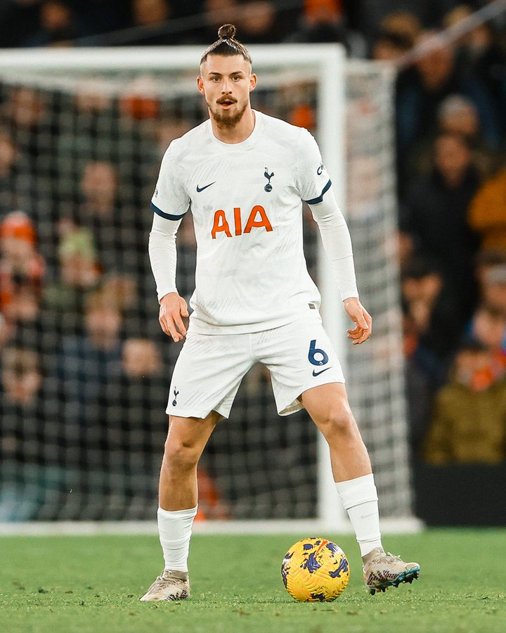 Radu Drăgușin considers his options on the ball.